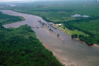 Aerial photo of a river and coastal infrastructure managing water flow to mitigate saltwater intrusion.