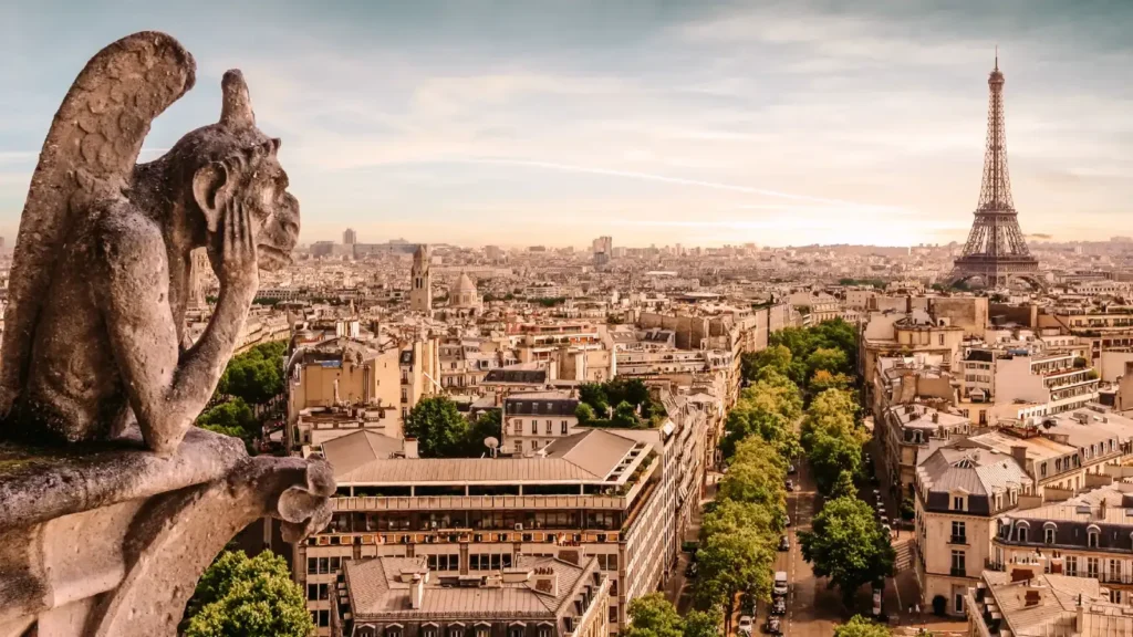 A breathtaking view of Paris, France, featuring the Eiffel Tower and a Notre-Dame gargoyle overlooking the cityscape.