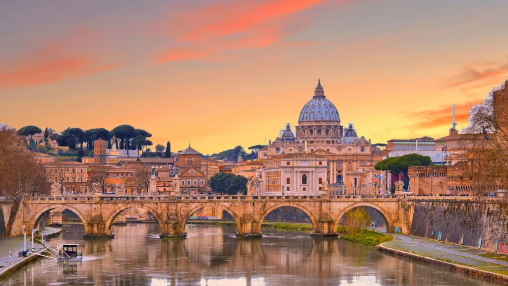 Breathtaking sunset over Rome, Italy, featuring St. Peter's Basilica and Ponte Sant'Angelo reflected in the Tiber River.